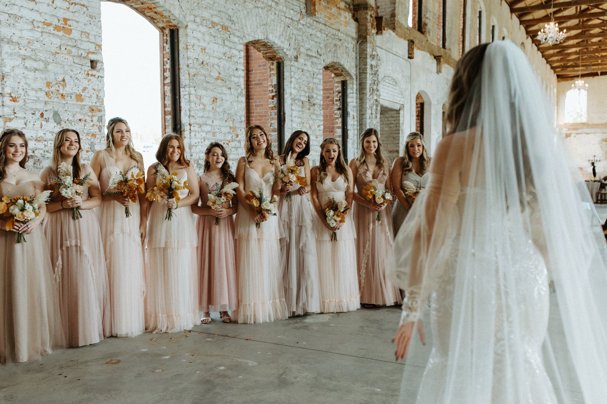 First look with bridesmaids at Providence Cotton Mill Wedding